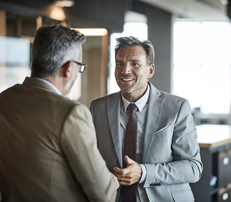 businessmen communicating in textile factory