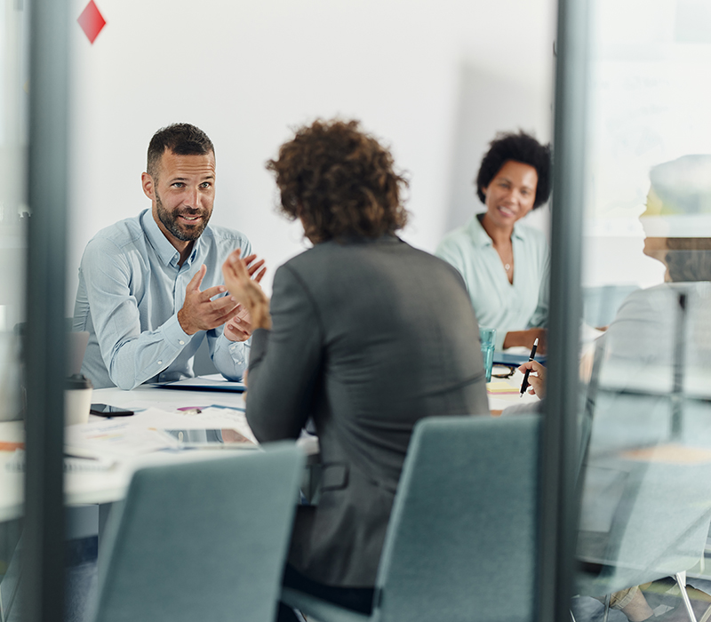 happy businessman talking to his colleague on a meeting in the office.